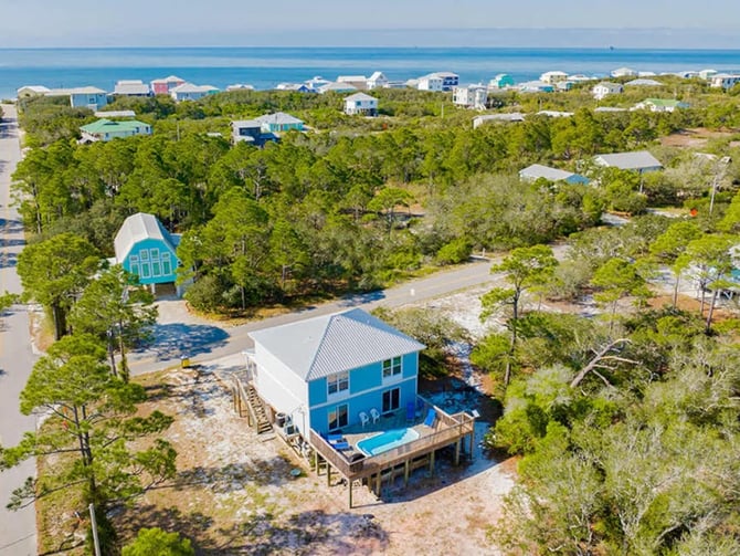 Aerial view of the Fort Morgan beach house with the Gulf of Mexico behind it